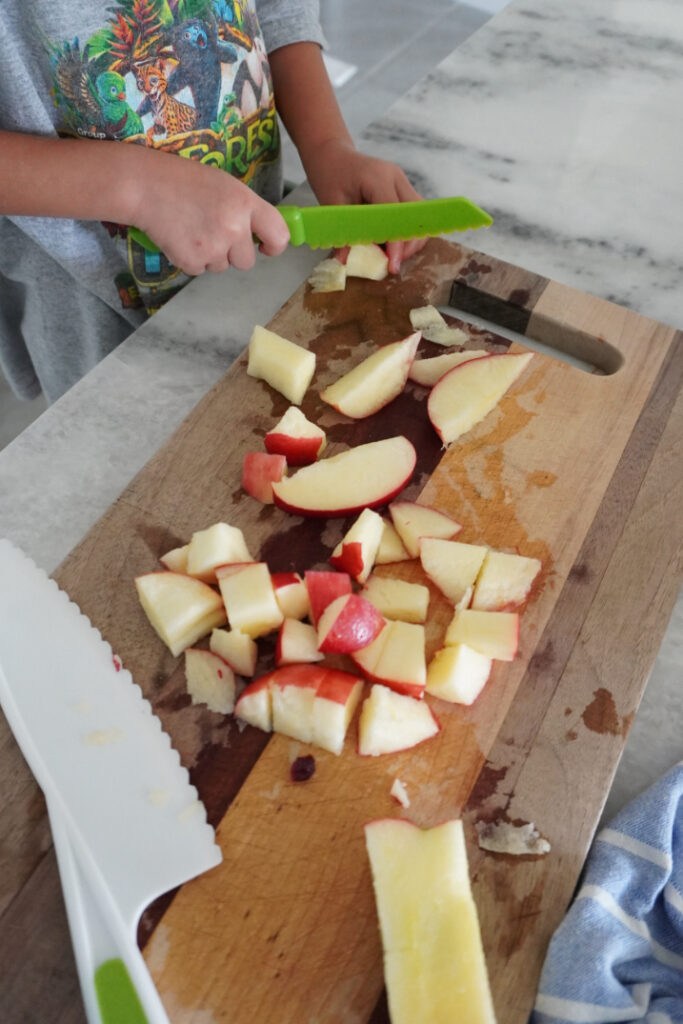 apples being chopped into pieces for baked apple cinnamon oatmeal