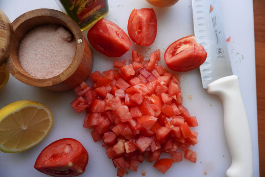 chopped tomatoes on a white cutting board