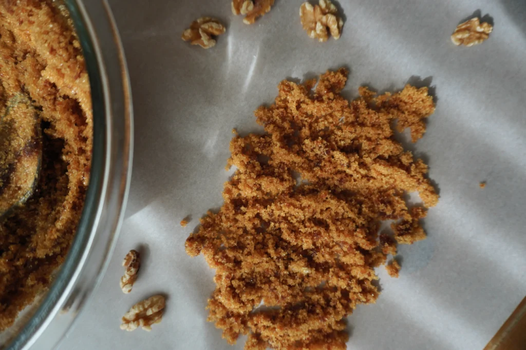 some brown sugar on parchment paper with walnuts