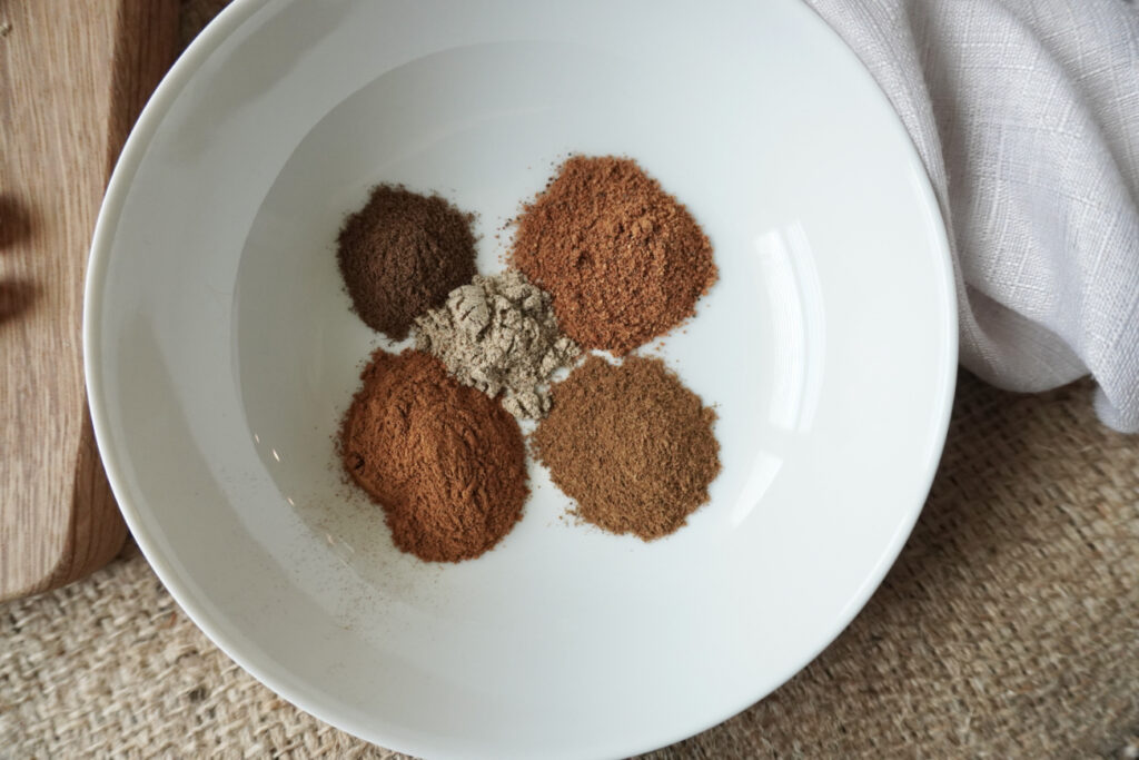 a white bowl of spices to make apple pie spice