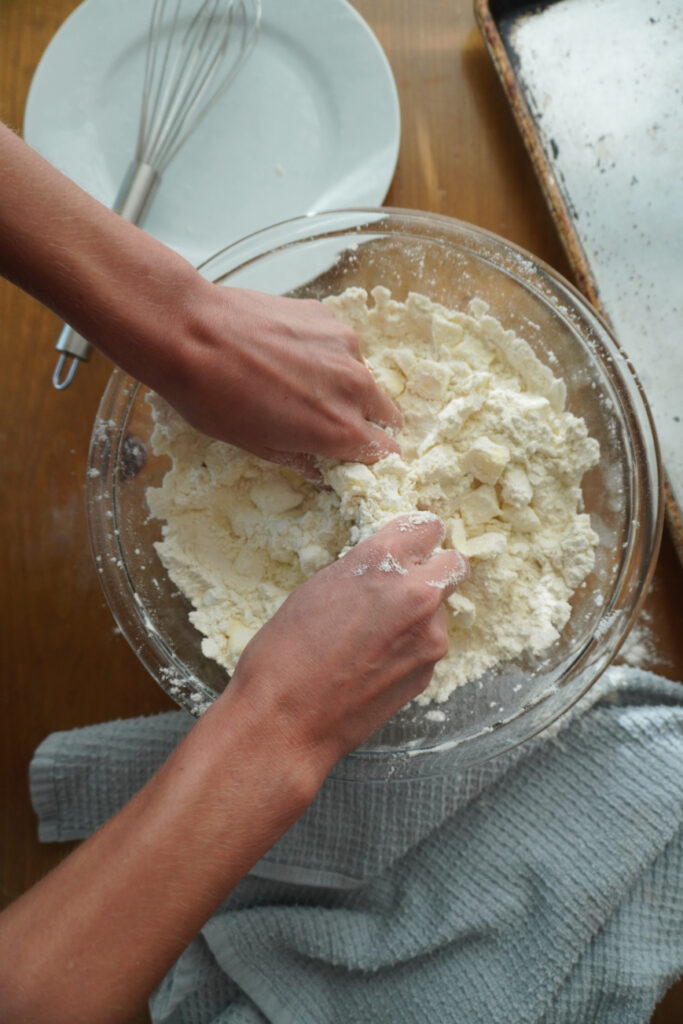 hands working butter into a flour mixture