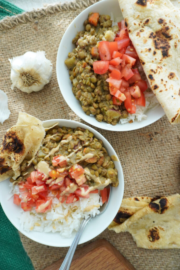 2 bowls of lentils with rice on a burlap background