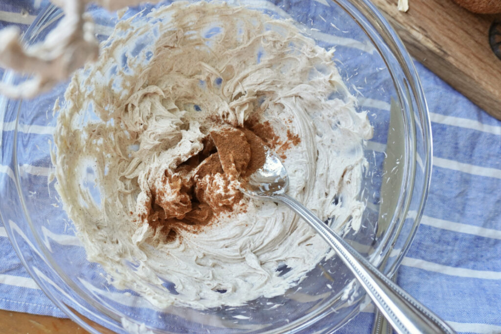 a mixing bowl of honey butter with cinnamon on top