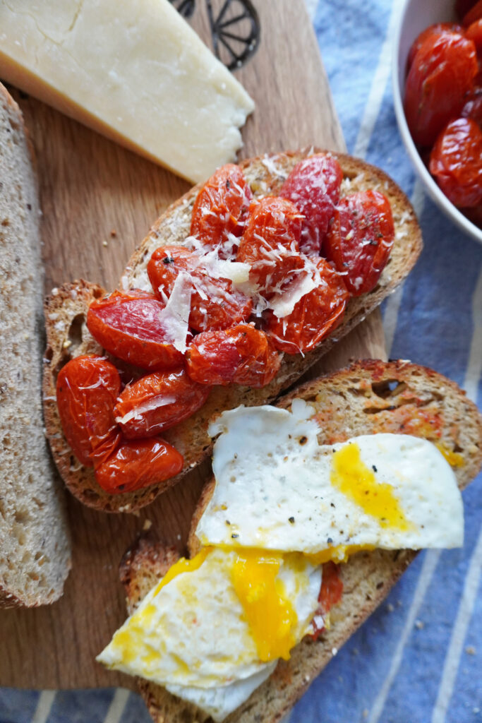 roasted tomatoes and eggs on slices of multigrain toast