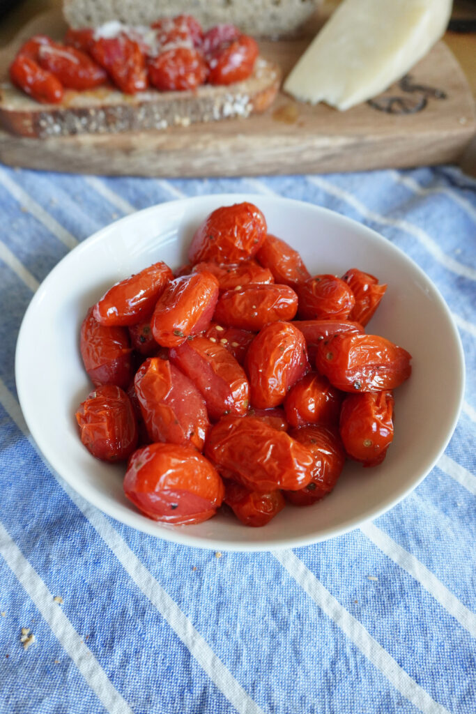 a white bowl of roasted grape tomatoes