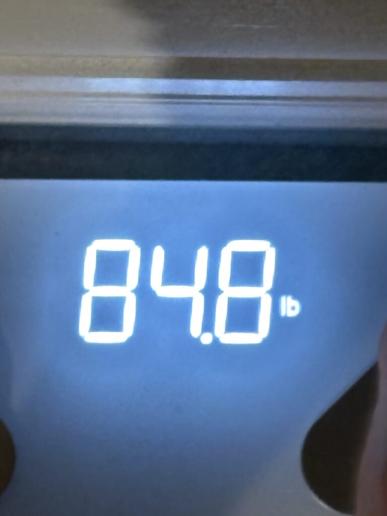 a scale showing 84.8lbs.